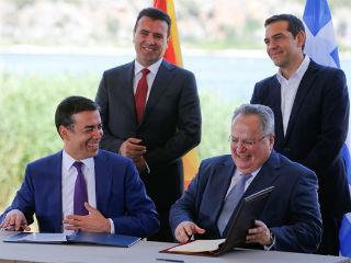 “By signing the agreement… we have really moved mountains,” he said, and offered Tsipras his tie.